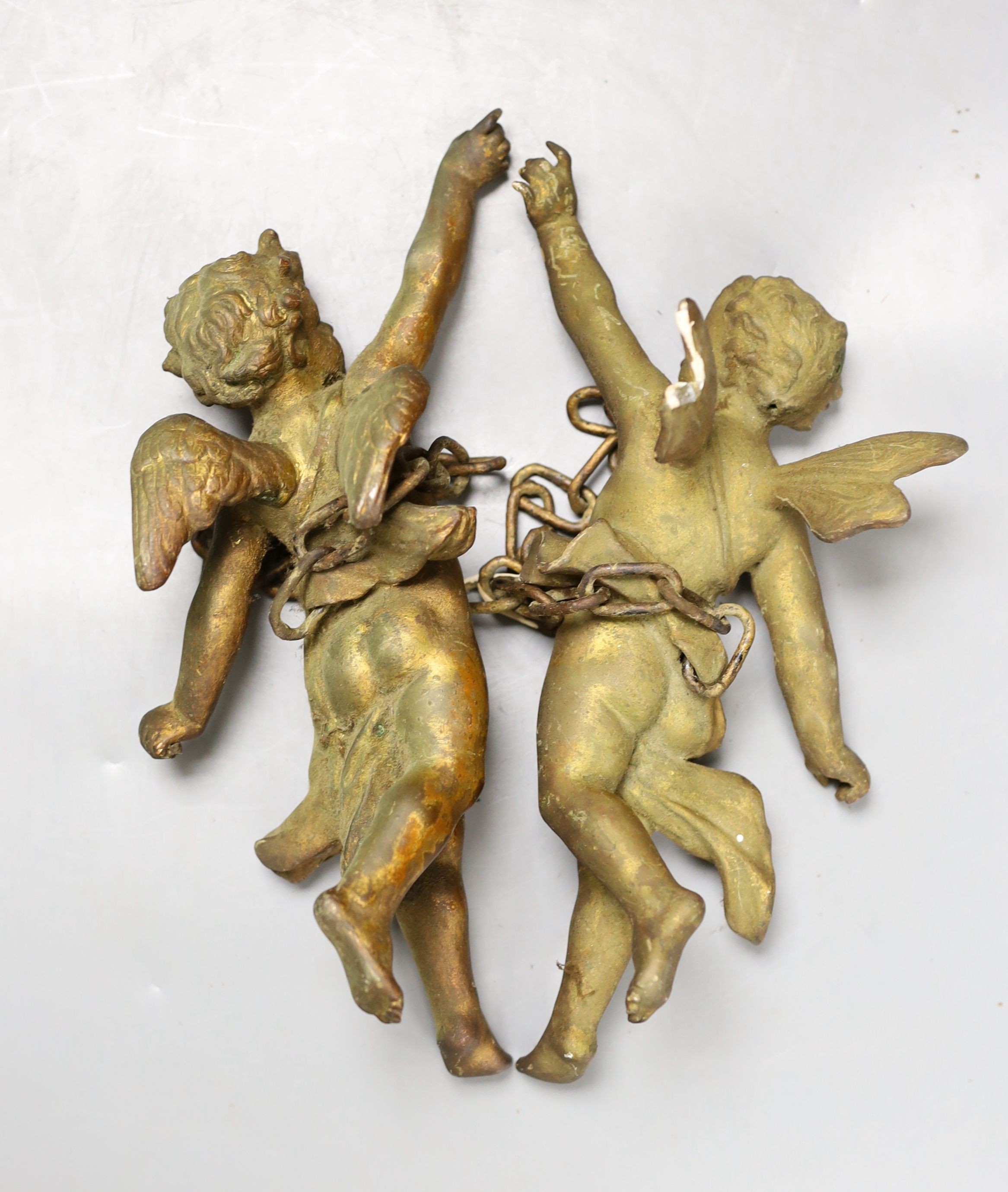 A pair of gilt metal cherub hanging figures, 26cm
